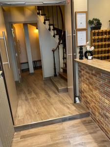 a hallway with a staircase and a brick floor at Angleterre Hotel in Paris