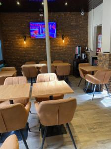 a room with tables and chairs and a tv at Angleterre Hotel in Paris +63 photos