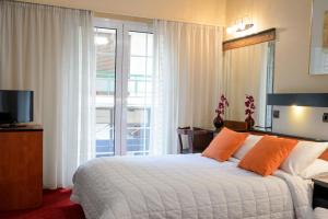 Posteľ alebo postele v izbe v ubytovaní Victory Inn Hotel