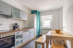 eine Küche mit einem Holztisch und einem Holztisch sidx sidx sidx in der Unterkunft Haus Godewind Typ 4 in Binz