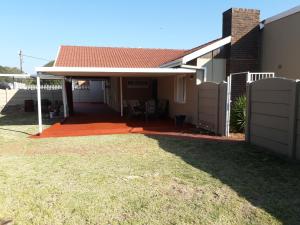 a house with a patio with a roof at Robertsham (Halaal) Self Catering Cottages in Johannesburg