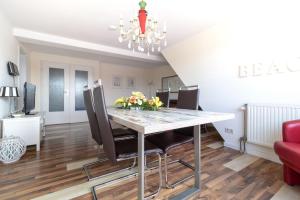 a dining room with a table and chairs at Haus-Godewind-Typ-4-1 in Binz