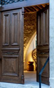 a large wooden door in a room with a chair at The Courtyard Episkopi Guest Houses in Episkopi Limassol