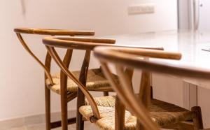 a pair of wooden chairs sitting at a table at The Courtyard Episkopi Guest Houses in Episkopi Limassol