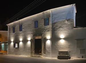 a white building with a door at night at The Courtyard Episkopi Guest Houses in Episkopi Limassol