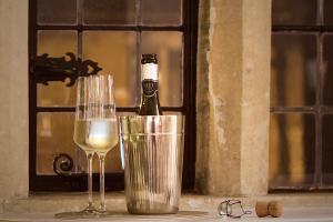 a bottle of wine and two glasses on a window sill at Cotswolds Place - Chancewell in Broadway