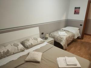 a hotel room with two beds and a mirror at Matisse1 in Bergamo