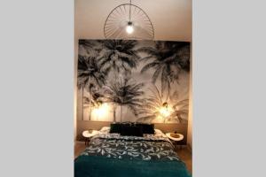 a bedroom with a bed and palm trees mural at T2 au calme , Centre Historique , Entrée Autonome in Montélimar