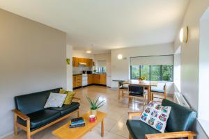 a living room with two couches and a table at Maynooth Campus Apartments in Maynooth