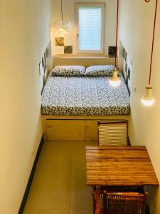 a small bedroom with two beds and a bench at The Nest / Il Nido in Polignano a Mare