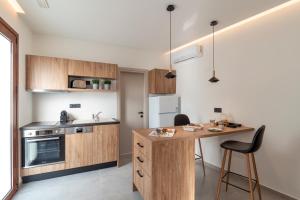 a kitchen with wooden cabinets and a wooden counter top at Giorgio Deluxe Studio in Kattavía