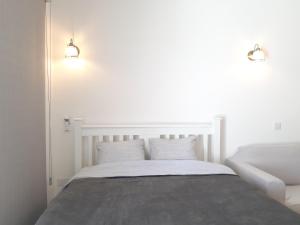 a bedroom with a white bed with two pillows at Sun sea B102 apartment by the beach in Limassol