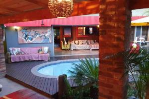 a patio with a swimming pool and a house at GILLFORD GALLERY ACCOMMODATION in Benoni