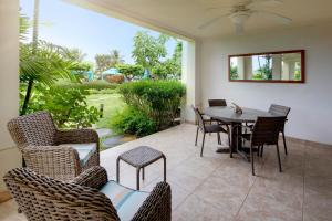 a patio with a table and chairs on a patio at Beach View Hotel in Saint James