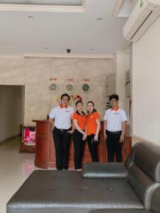 a group of people standing in a living room at Ph&uacute; Ho&agrave;ng Nam Hotel in Ho Chi Minh City
