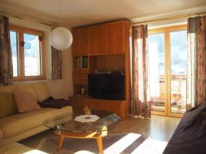 a living room with a couch and a coffee table at Ferienwohnung Hildegard in Silbertal