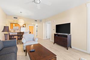 a living room with a couch and a flat screen tv at Elation 5605 Bliss by the Bay in Destin