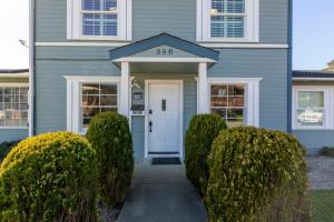 a blue house with a white front door at @ Marbella Lane - Buckingham Place Laundry + P in Pacifica