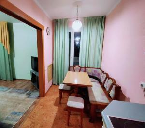 a living room with a table and a couch at Апартаменты Харьковская in Sumy +4 photos