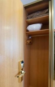 a door is open to a small room with a wooden shelf at Hotel Hispania in Zaragoza