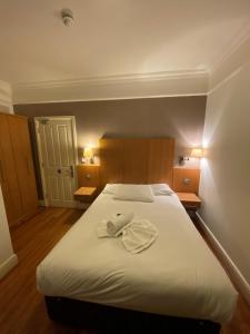 Postel nebo postele na pokoji v ubytování Buckingham Hotel