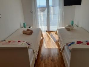 Postel nebo postele na pokoji v ubytování Apartmani Frano