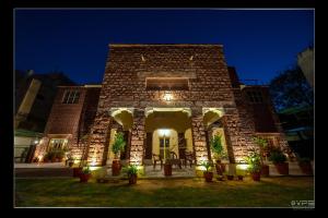 a brick building with lights on it at night at A Heritage Homestay in Jodhpur +33 photos