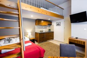 a bedroom with a bunk bed and a desk at Apartamenty Brzozowa - Centrum in Zakopane