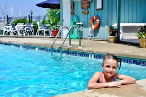 a little girl laying in a swimming pool at Inn at Haven Harbour in Rock Hall