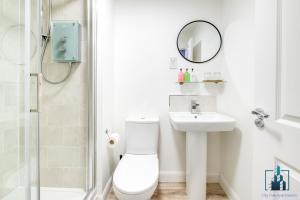 a bathroom with a toilet and a sink and a mirror at City View Apartments B5 Central City Centre in Birmingham