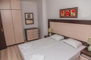 A bed or beds in a room at OLYMP Apart-Complex