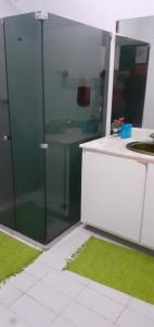 a glass shower in a kitchen with a sink at Regiane Beach Pousada Hostel in João Pessoa