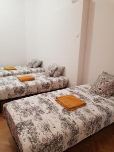 two beds in a room with orange towels on them at Rainbow Guest House in Lisbon