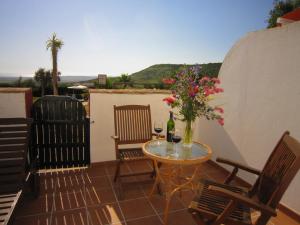 
a table that has some chairs around it at Hotel Sindhura in Vejer de la Frontera
