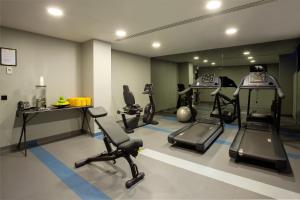 a gym with treadmills and exercise equipment in a room at Altis Avenida Hotel, a member of Preferred Hotels & Resorts in Lisbon