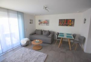 a living room with a couch and a table at Ferienwohnung Hegaublüte in Engen