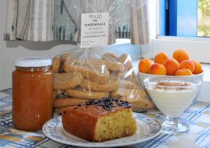 a plate with a loaf of bread and a bowl of fruit at Filio rooms in Kythira