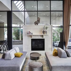 a living room with two couches and a fireplace at The Listel Hotel Vancouver in Vancouver