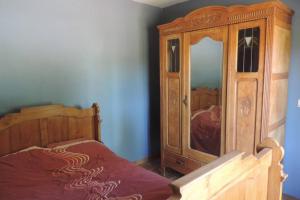a bedroom with a wooden cabinet and a bed at Vakantiewoning Zoetebeek in Oudenaarde