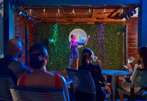 a group of people watching a woman on a stage at R Hotel Kingston in Kingston