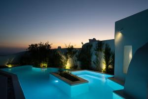 a swimming pool with blue lighting in a house at Sunset View Villa with Swimming Pool & Heated Jacuzzi in Pyrgos