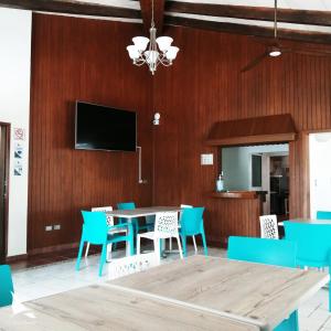 a dining room with a table and blue chairs at Hotel Casa Grande Cancun in Cancún