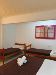Łóżko lub łóżka w pokoju w obiekcie Anexo Aldeia Búzios