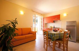 a kitchen and living room with a table and a couch at Appartamenti - Villa Mare in Pomonte