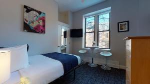 a hotel room with a bed and a window at Stylish Downtown Studio in the SouthEnd, C.Ave #43 in Boston
