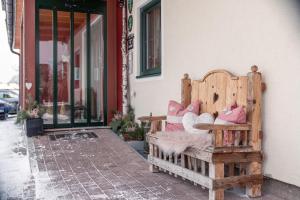 a wooden bench sitting outside of a building at Wellnesshaus Reichelt in Radstadt