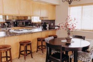 a kitchen with a table and chairs and a counter at Pacific Inn Motel in Forks