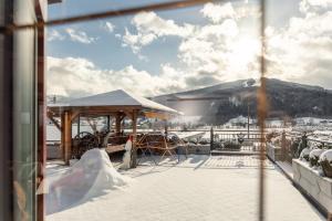 a view from a window of a snow covered roof at Wellnesshaus Reichelt in Radstadt