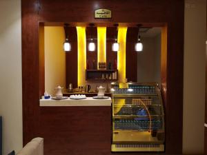 a kitchen with a counter with yellow columns at Makarem Hotel Apartment - مكارم للشقق الفندقية in Riyadh