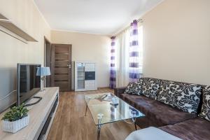 a living room with a couch and a coffee table at NotaBene Wola Apartment in Warsaw